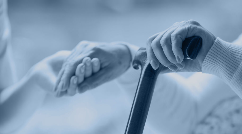 Elderly hands on walking cane, aged care